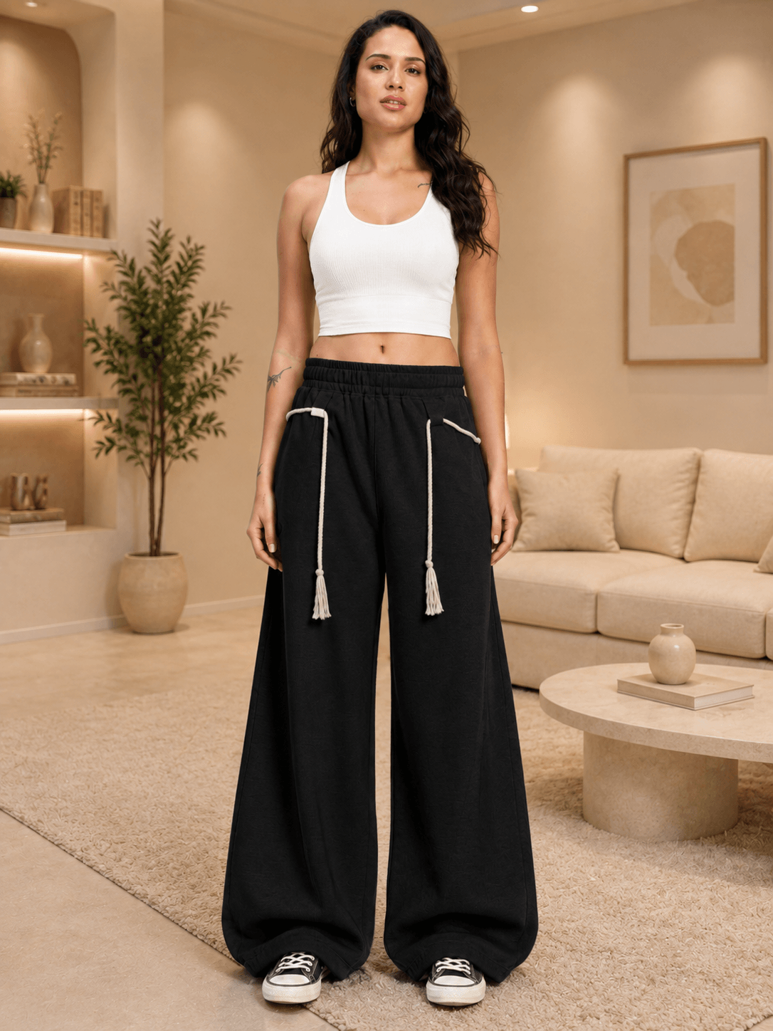 WOMEN COOLFIT BAGGY LOOSE FIT JOGGER BLACK worn by a model in a stylish interior setting.