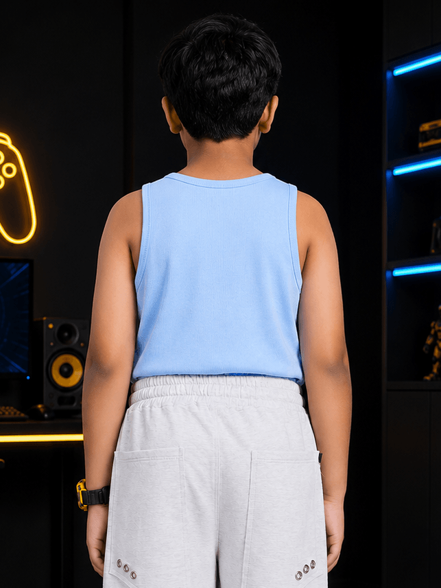 EASY WEAR VEST T-SHIRT FOR BOYS GIRLS SKY BLUE shown from the back, worn by a child in a modern setting.