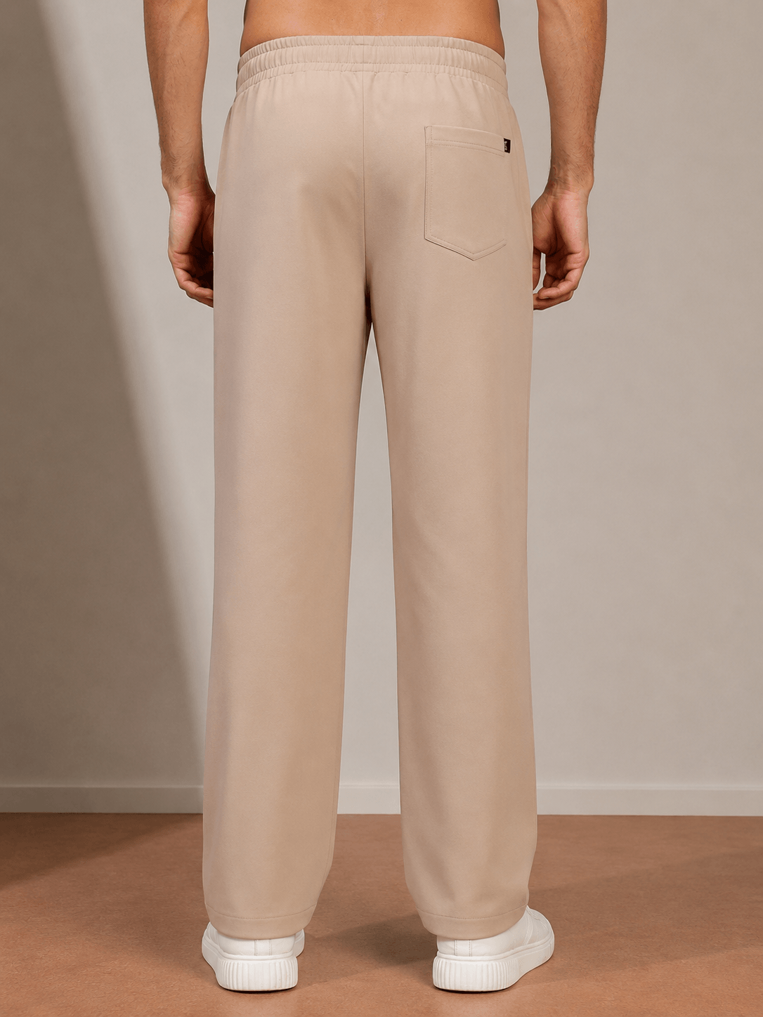 Back view of ATHLETIC DRESS TRACK TROUSERS BEIGE, showcasing comfortable fabric and relaxed fit.