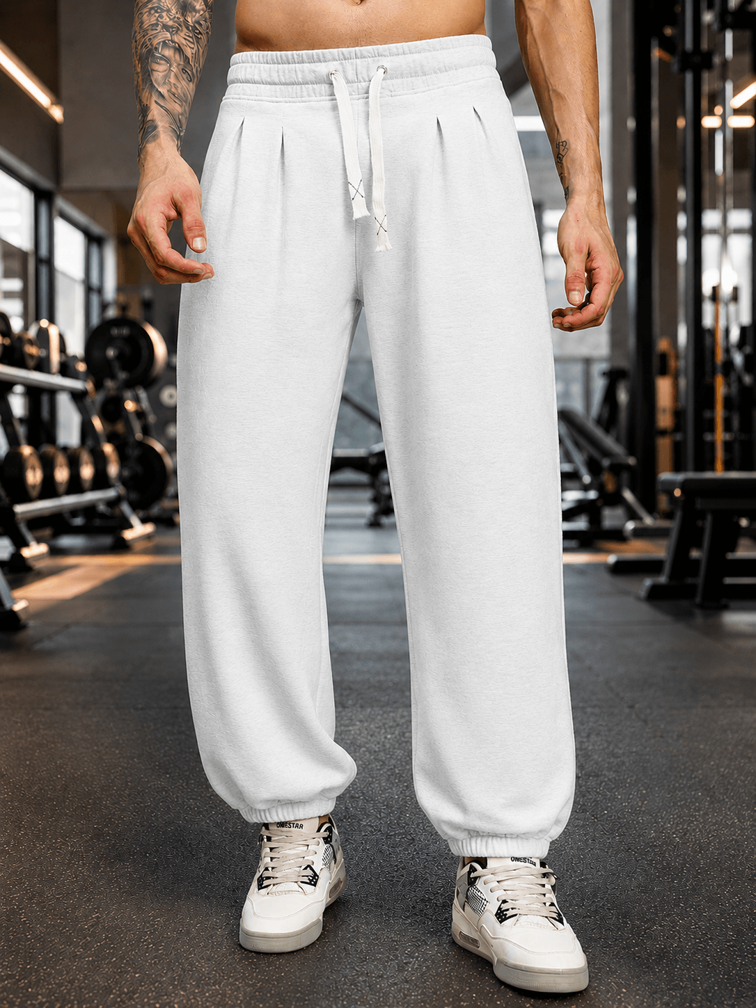 COOLFIT BAGGY LOOSE FIT JOGGER WHITE displayed on a model in a gym setting, showcasing its stylish and comfortable design.