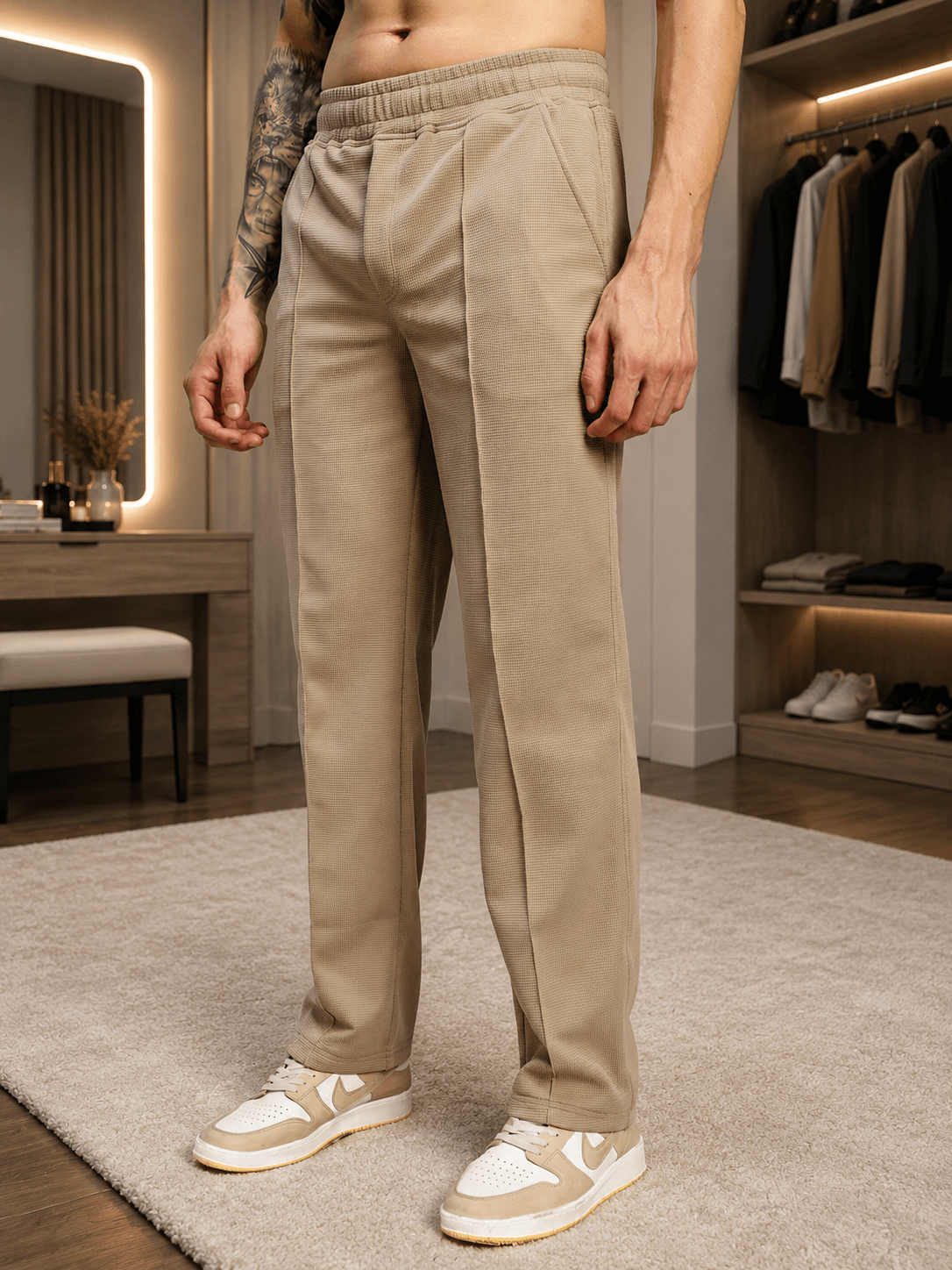 ELITE TEXTURED FIT JOGGERS BEIGE shown in a stylish indoor setting, highlighting the tailored fit and modern design.