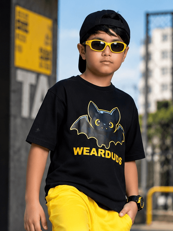 Midnight Bat T-Shirt for Boys Girls Black worn by a kid with sunglasses and a black cap outdoors.