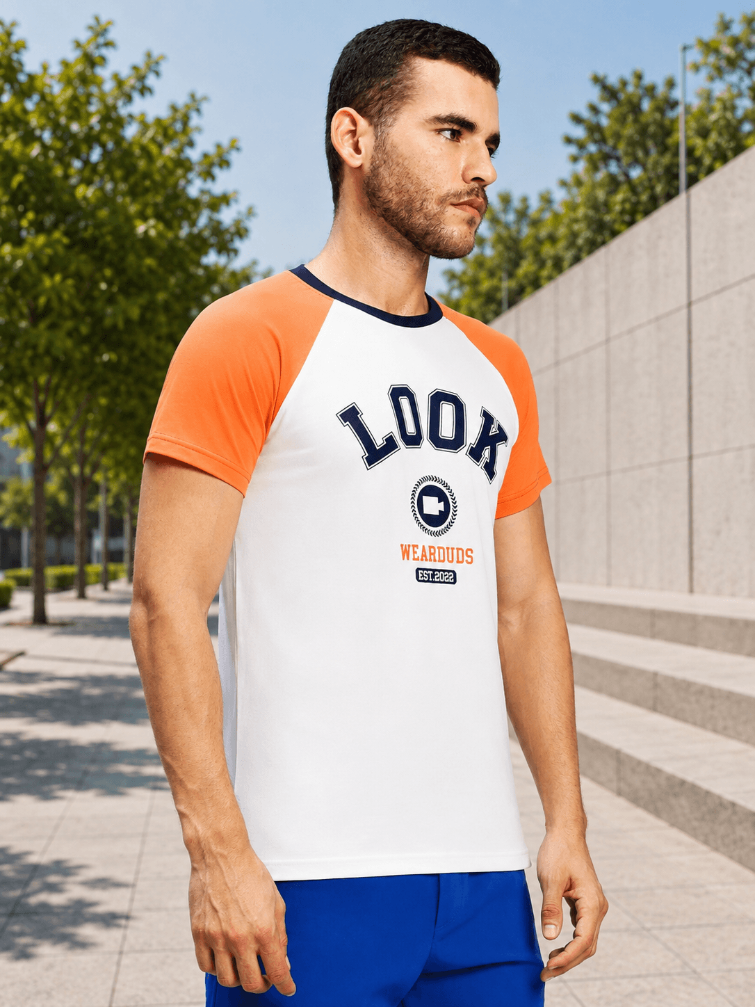 VINTAGE LOOK GRAPHIC CASUAL T-SHIRT WHITE worn by a man outdoors, showcasing its retro and casual style.
