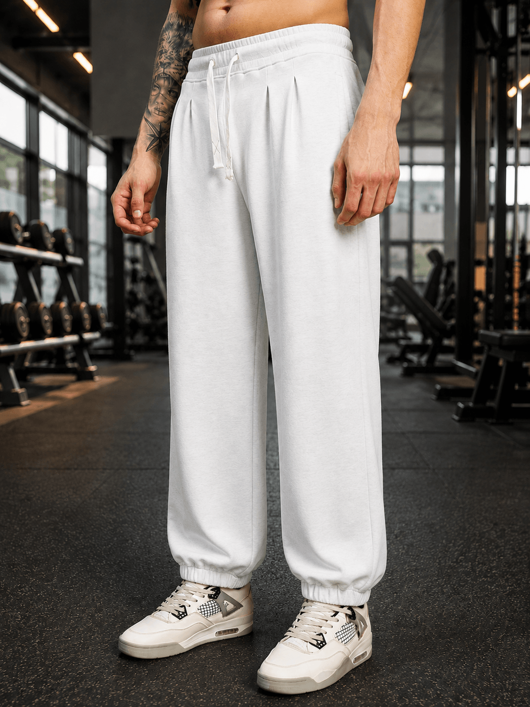 COOLFIT BAGGY LOOSE FIT JOGGER WHITE displayed on a person in a gym setting, showcasing a trendy and relaxed fit.