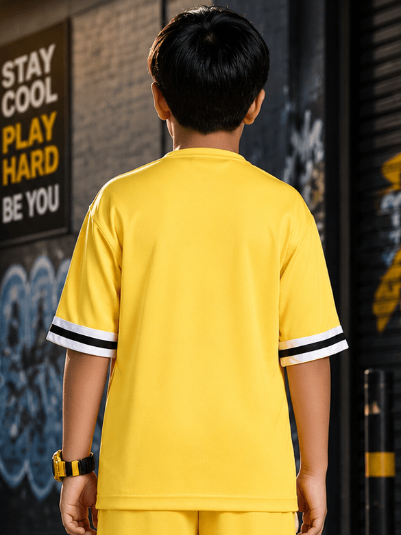 Back view of a child wearing THE STREET T-SHIRT FOR BOYS GIRLS YELLOW with striped sleeves.