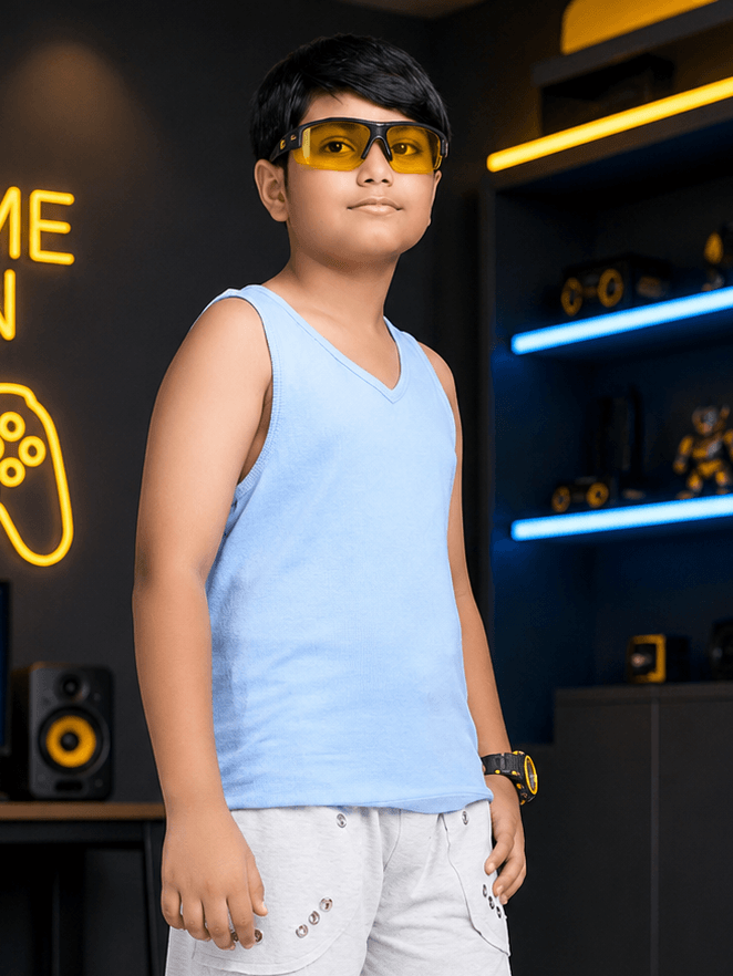 EASY WEAR VEST T-SHIRT FOR BOYS GIRLS SKY BLUE worn by a boy in stylish sunglasses and casual shorts.