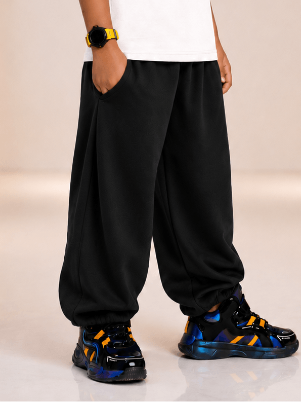 COOLFIT JOGGER FOR BOYS GIRLS BLACK worn by a child, showcasing modern sport style and comfort in casual settings.
