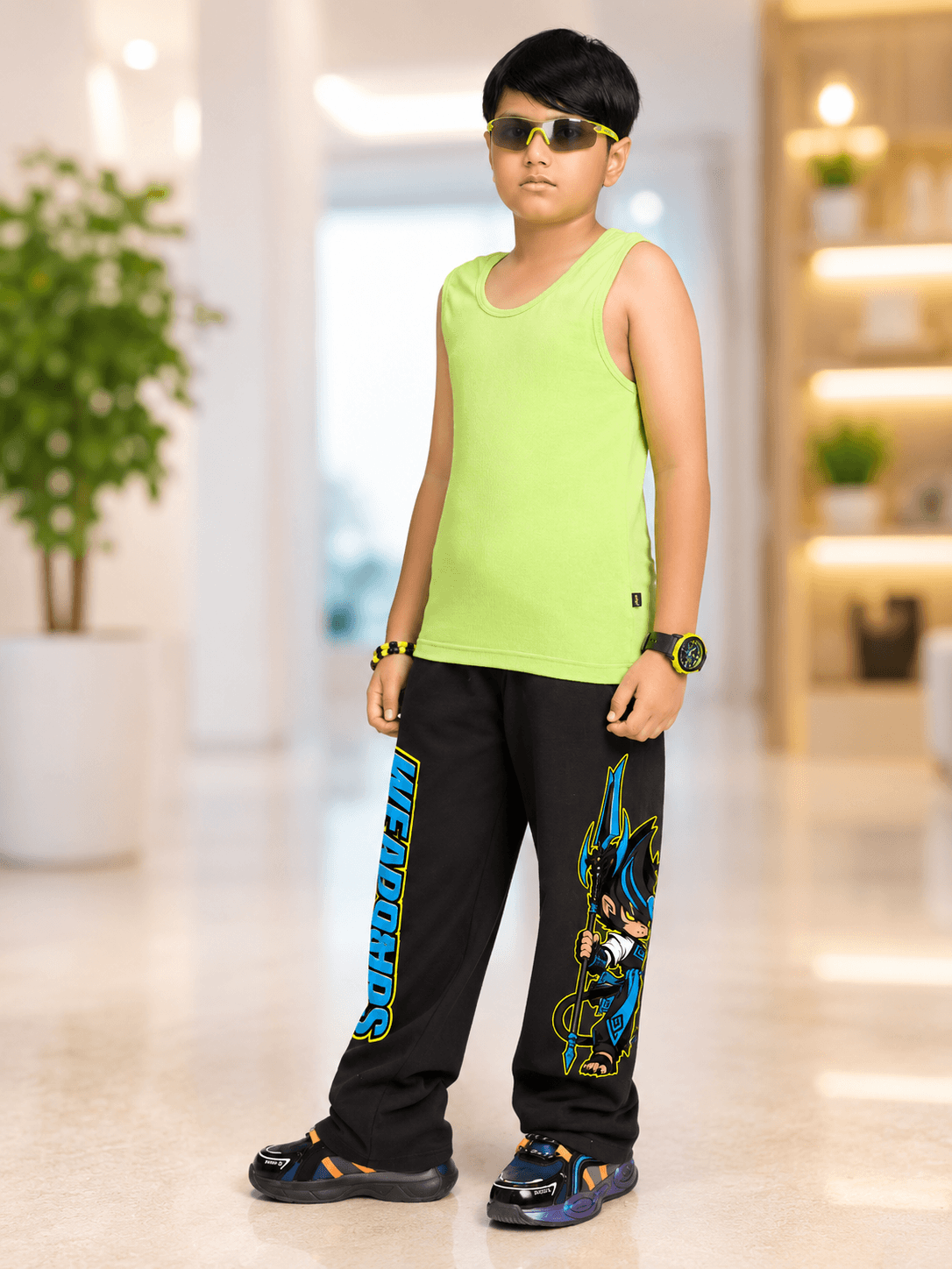 Boy wearing Electric Warrior Co-Ord for Boys Girls Neon Black, vibrant green tank top and stylish black pants.