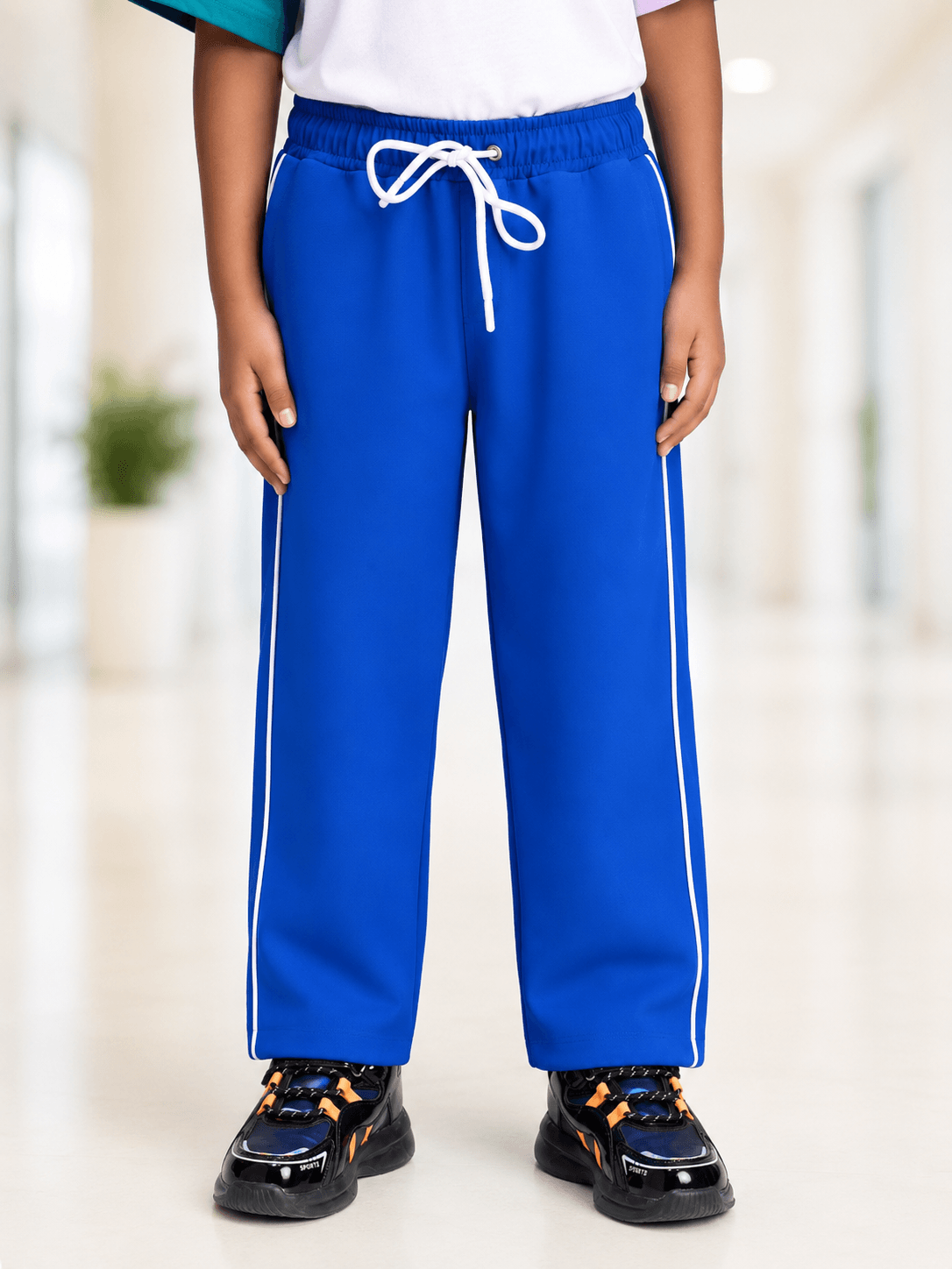 RELIGHT RELAXED FIT JOGGER FOR BOYS GIRLS ROYAL BLUE worn by a child, showcasing vibrant color and comfortable design.