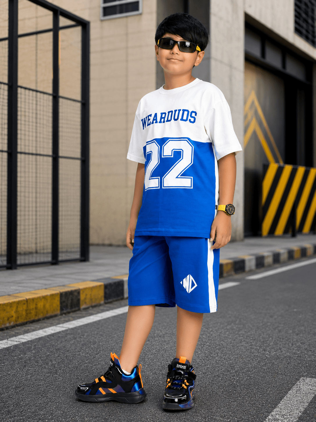 ELECTRIC FLEX CO-ORD FOR BOYS GIRLS WHITE BLUE worn by a child in stylish blue outfit with sporty sunglasses.