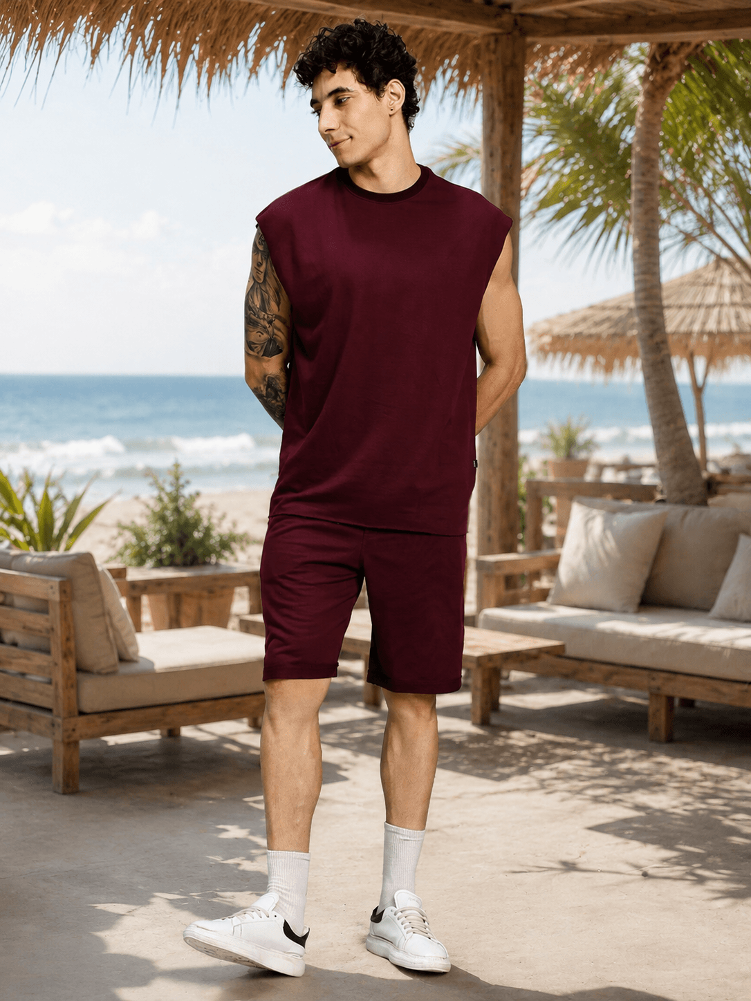 DRIVE MONOCHROME CO-ORD SET MAROON model wearing a sleeveless top and shorts by the beach.