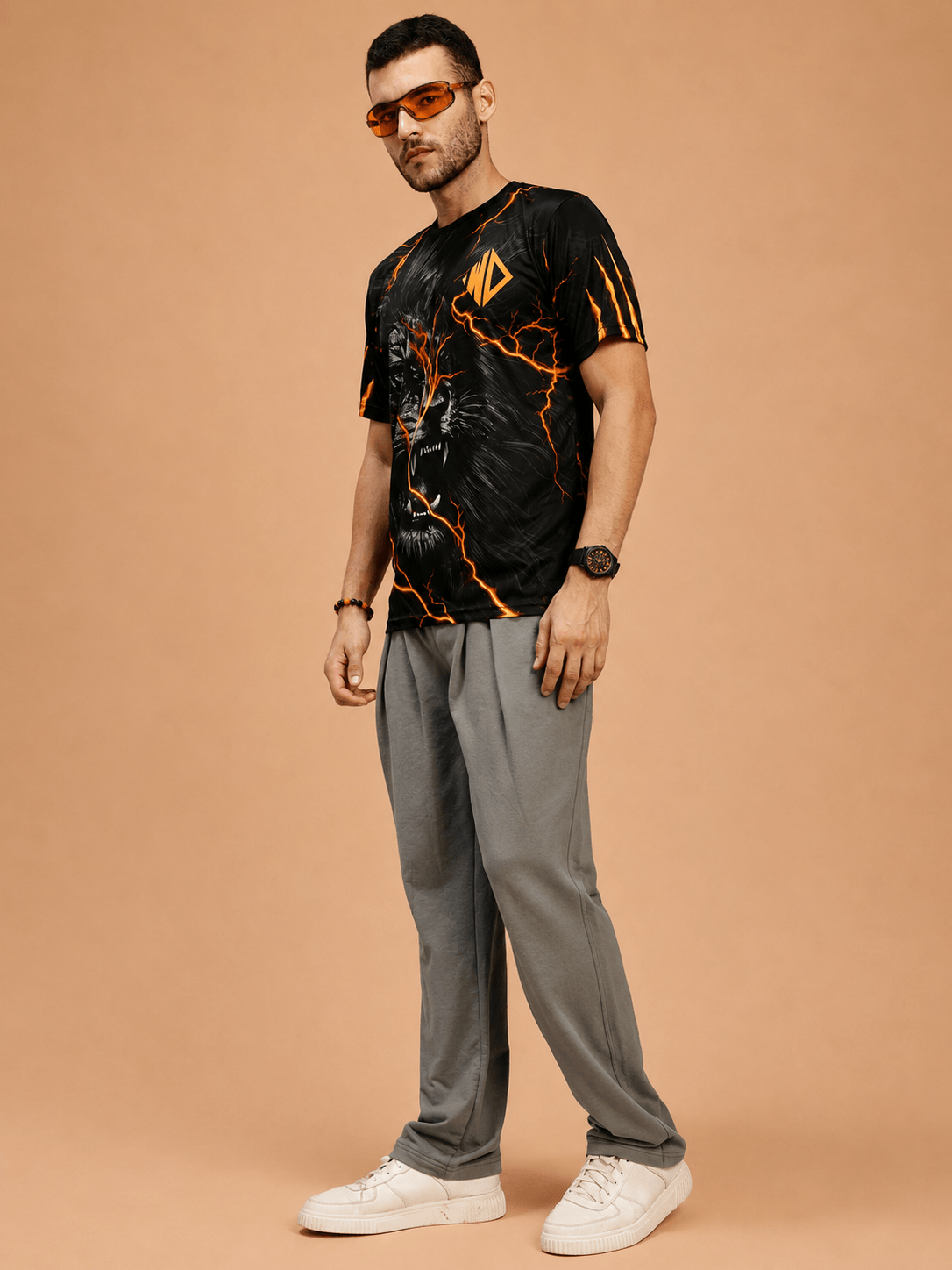 WILD LIFE POWER GRAPHIC RUNNING T-SHIRT BLACK ORANGE modeled by a man in stylish athletic wear.