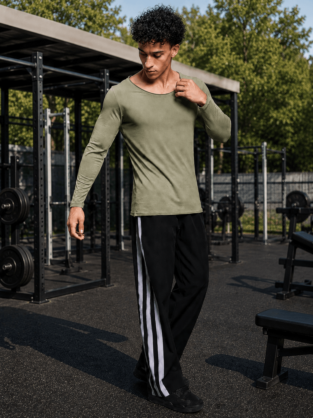 Model wearing JOEL SLIM FIT COTTON SWEATSHIRT SAGE GREEN during workout in outdoor gym setting.