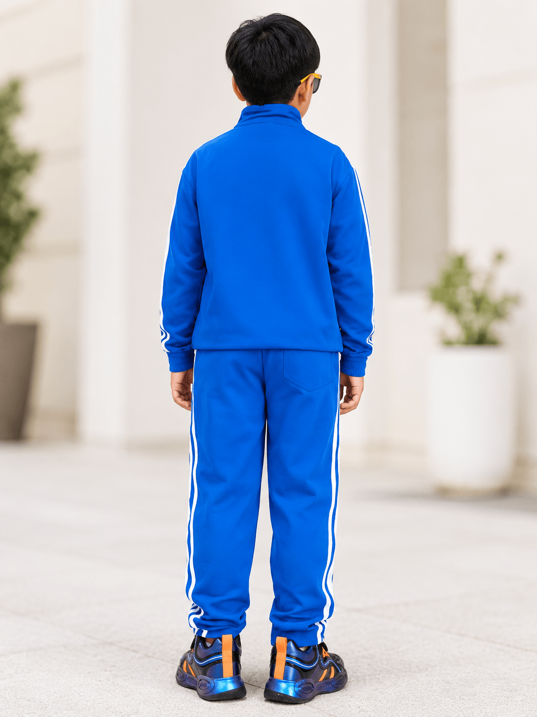 SPORTY ZIP UP CO-ORD SET FOR BOYS AND GIRLS ROYAL BLUE worn by a child from behind, showcasing the bold color and sporty design.