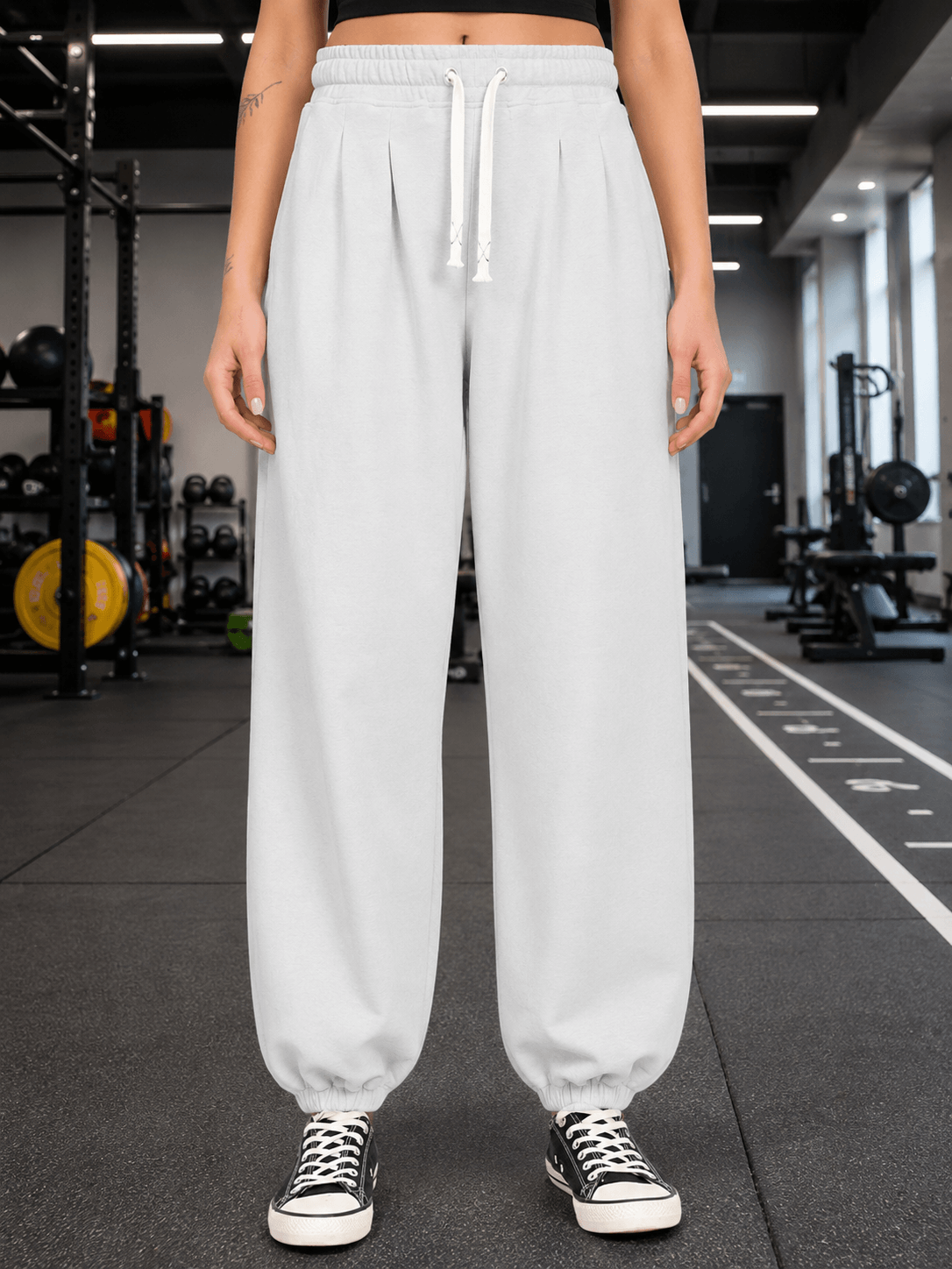 WOMEN COOLFIT BAGGY LOOSE FIT JOGGER WHITE displayed on a model in a gym setting, showcasing relaxed athleisure style.
