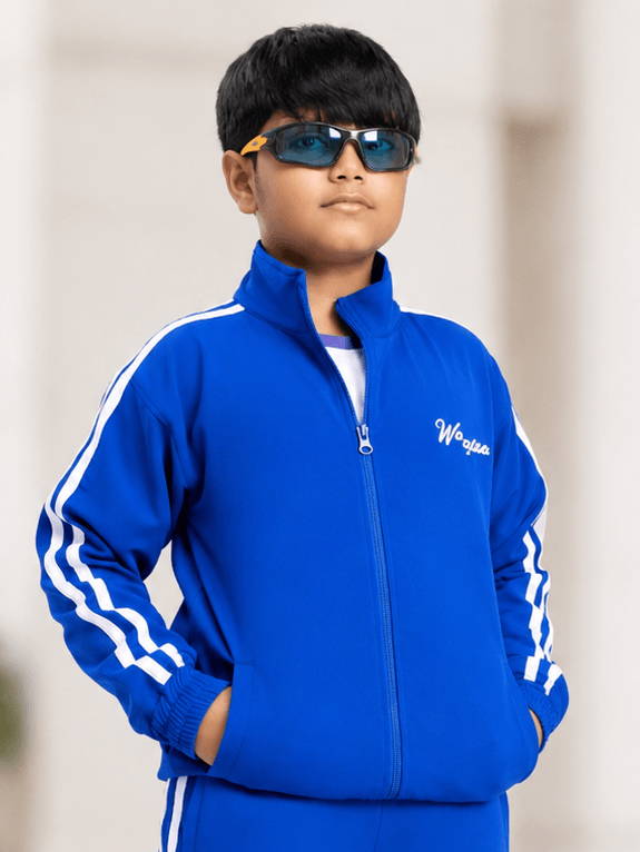 SPORTY ZIP UP JACKET FOR BOYS GIRLS ROYAL BLUE worn by a stylish kid with sunglasses, showcasing sporty fashion.