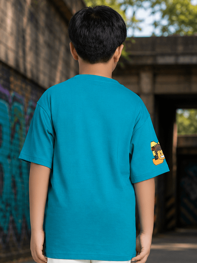 JUNIOR T-SHIRT FOR BOYS GIRLS BLUE worn by a child, showcasing the back design with vibrant blue color.