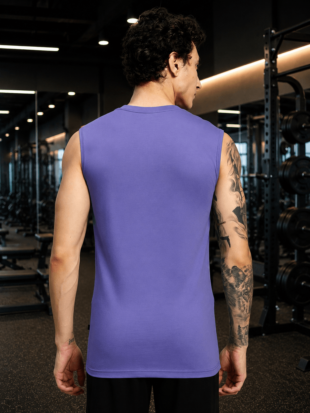 LEVELUP GAMER SLEEVELESS T-SHIRT PURPLE worn by a man in a gym setting, showcasing the back design.