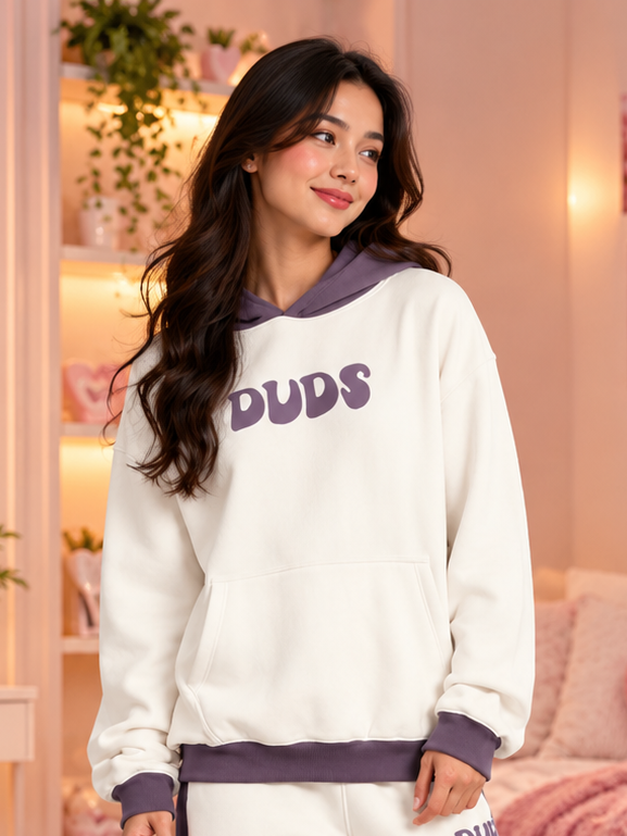 WOMEN SELF LOVE FLEECE OVERSIZED HOODIE WHITE VIOLET worn by smiling model in cozy pink room setting