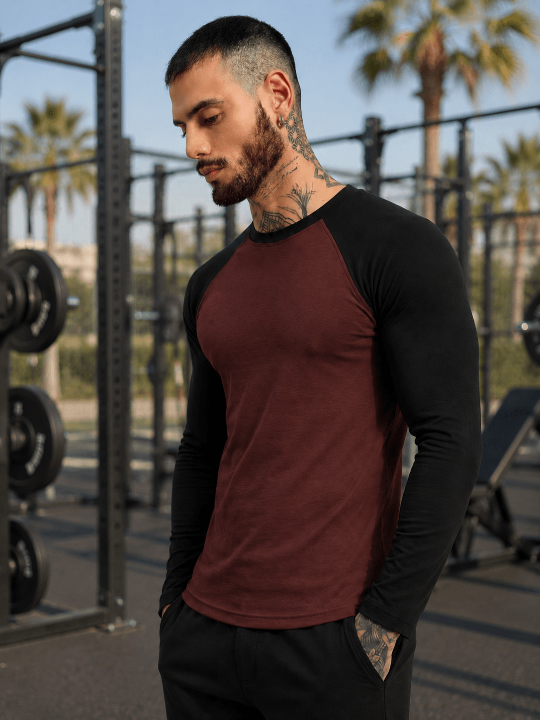FITFLOW SLIM FIT SWEATSHIRT BROWN BLACK worn by a man in a fitness setting with palm trees in the background.