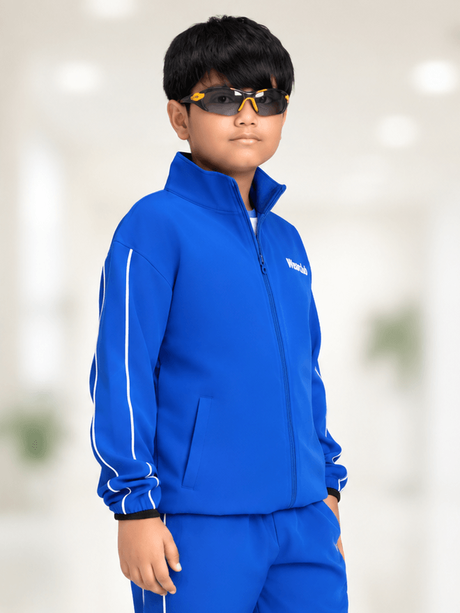 RELIGHT RELAXED FIT JACKET FOR BOYS GIRLS ROYAL BLUE worn by a boy with sunglasses, showcasing sporty style.