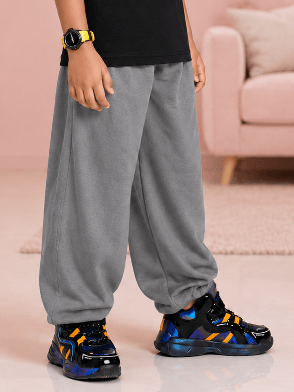 COOLFIT JOGGER FOR BOYS GIRLS GREY showcased on a child paired with stylish sneakers and a relaxed fit.
