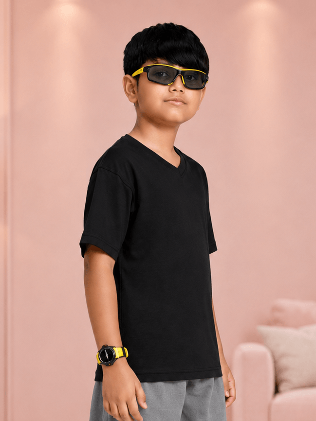 COOLFIT T-SHIRT FOR BOYS GIRLS BLACK worn by a stylish boy with sunglasses, showcasing modern streetwear.