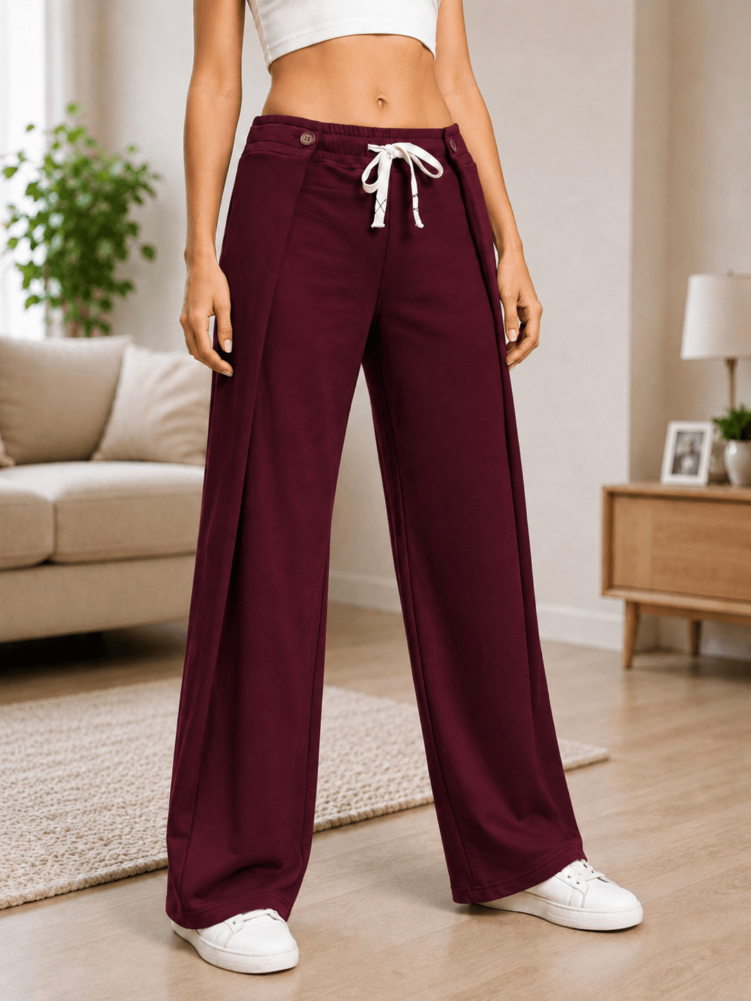 WOMEN OMEGA FLOW WIDE FIT JOGGERS MAROON in relaxed style, showcasing their flowy silhouette and deep maroon color.
