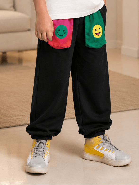 EMOJI VIBES JOGGER FOR BOYS GIRLS BLACK with playful emoji pockets and stylish sneakers.