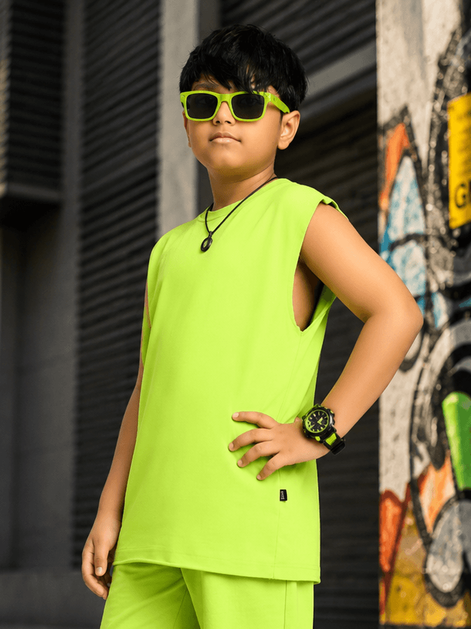 NEON RUSH SLEEVELESS T-SHIRT FOR BOYS GIRLS NEON GREEN worn by a boy in bright neon green against a graffiti backdrop.