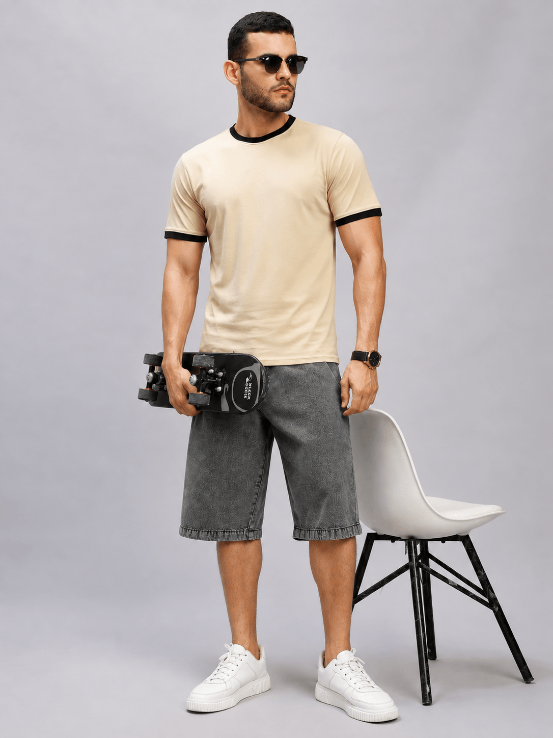 MAN WEARING MINIMALIST CONTRAST EDGE T-SHIRT BEIGE WITH DUMBBELLS AND DENIM SHORTS