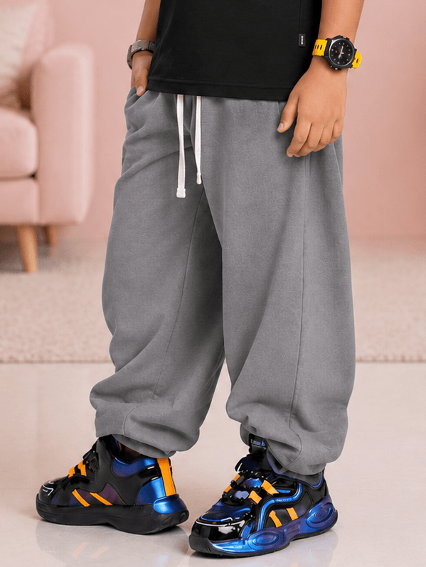 COOLFIT JOGGER FOR BOYS GIRLS GREY worn by a child, paired with stylish sneakers, showcasing comfortable streetwear style.