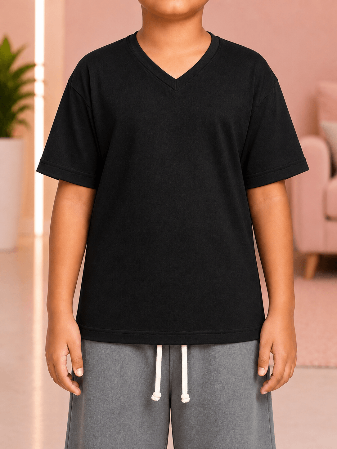 COOLFIT T-SHIRT FOR BOYS GIRLS BLACK worn by a child, showcasing modern streetwear style in a classic black shade.