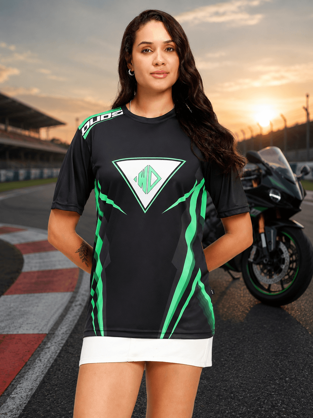 Women Apex Racing Regular T-Shirt Black worn by a model at a racetrack, showcasing a sporty and stylish look.