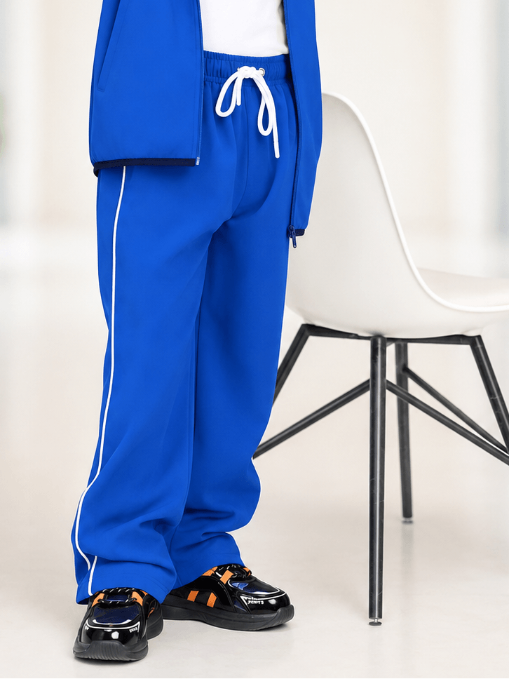 RELIGHT RELAXED FIT JOGGER FOR BOYS GIRLS ROYAL BLUE shown with white side stripes and paired with stylish shoes.