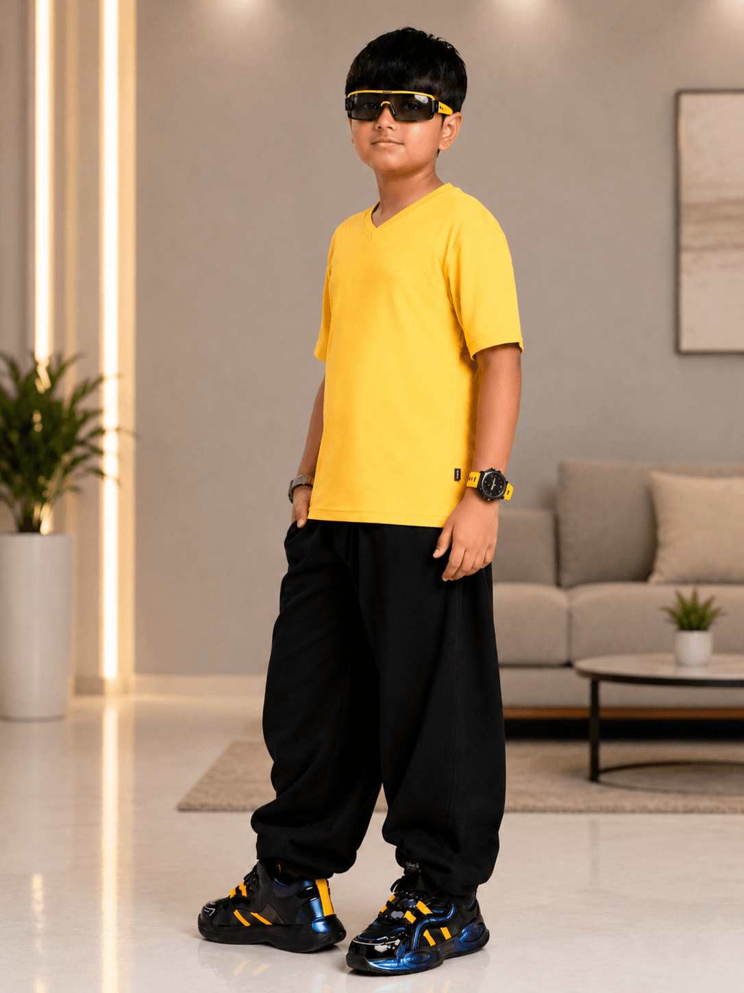 COOLFIT T-SHIRT FOR BOYS GIRLS YELLOW worn by a boy posing confidently in a stylish outfit.