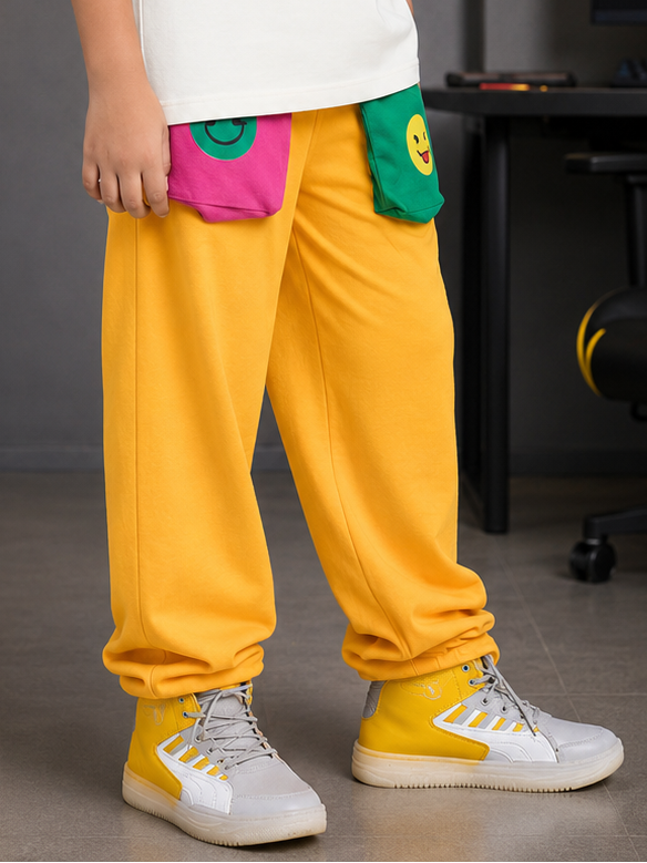 EMOJI VIBES JOGGER FOR BOYS GIRLS YELLOW with playful pockets and bright yellow color, ideal for kids' fashion.
