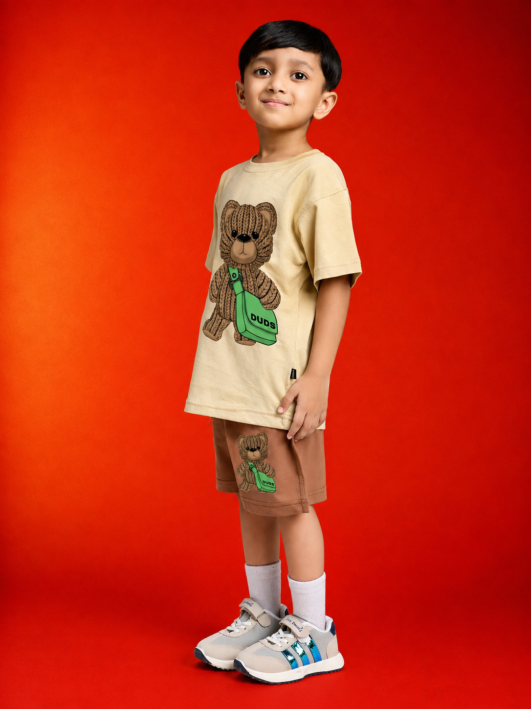 LITTLE EXPLORER TEDDY CO-ORD FOR BOYS GIRLS BEIGE BROWN model wearing beige teddy design outfit