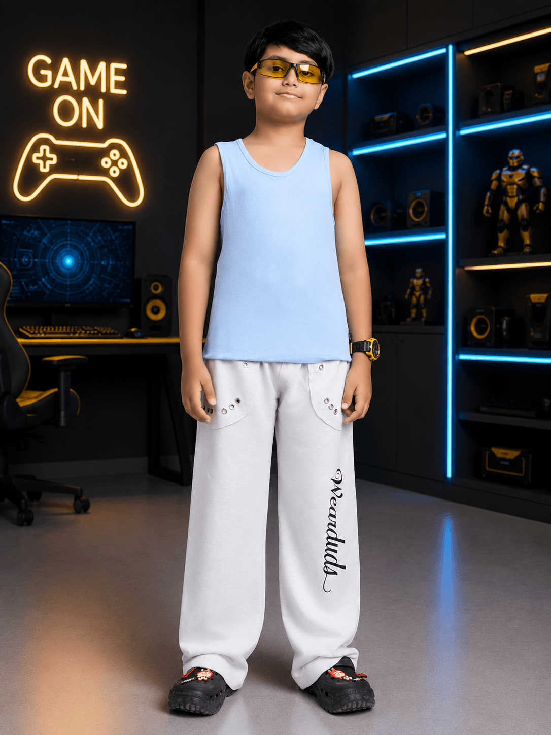 EASY WEAR VEST T-SHIRT FOR BOYS GIRLS SKY BLUE worn by a boy in a gaming room, complementing casual outfit.