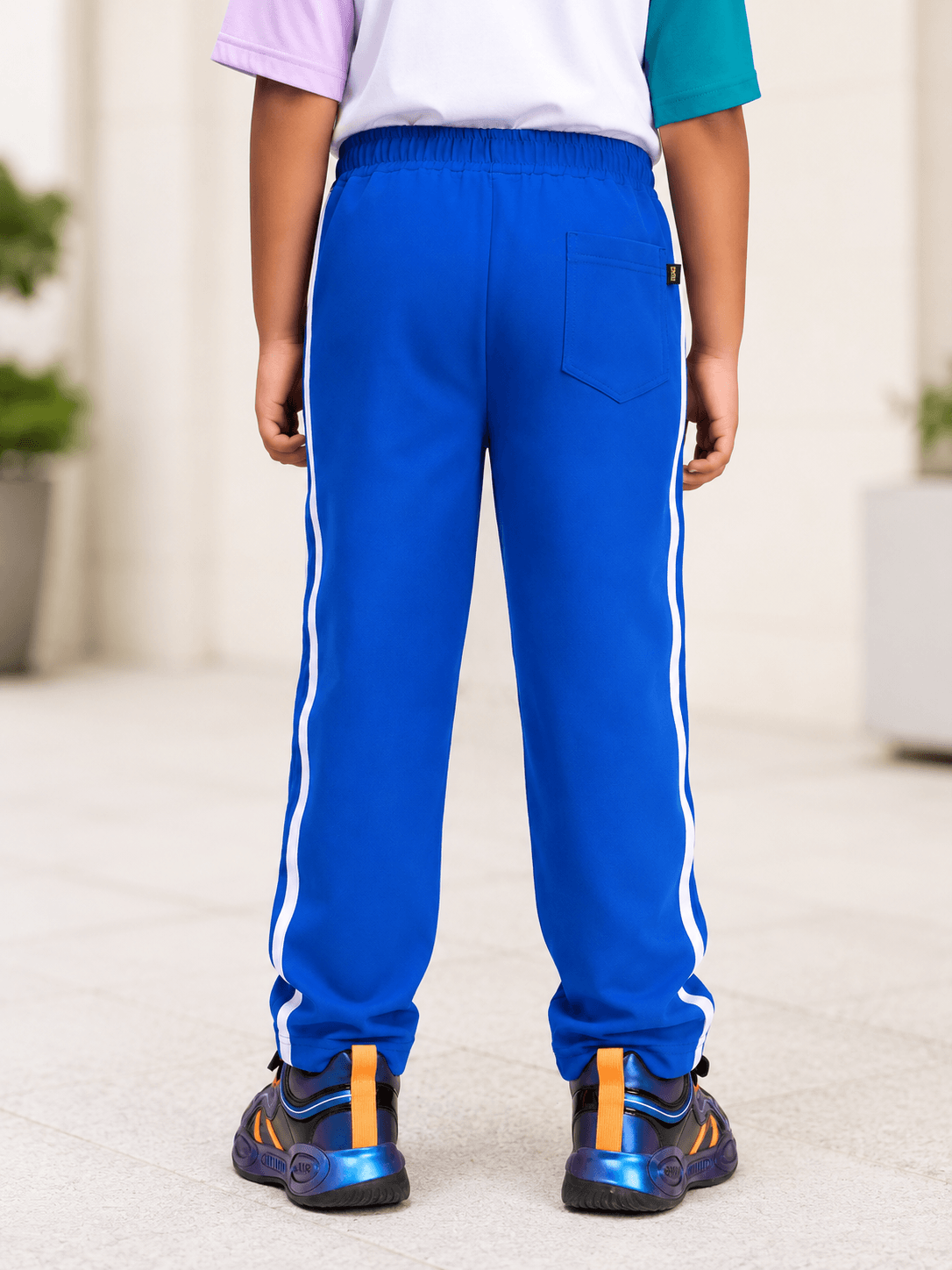 Sporty zip up co-ord set for boys and girls royal blue, showcased from the back with stylish athletic pants.