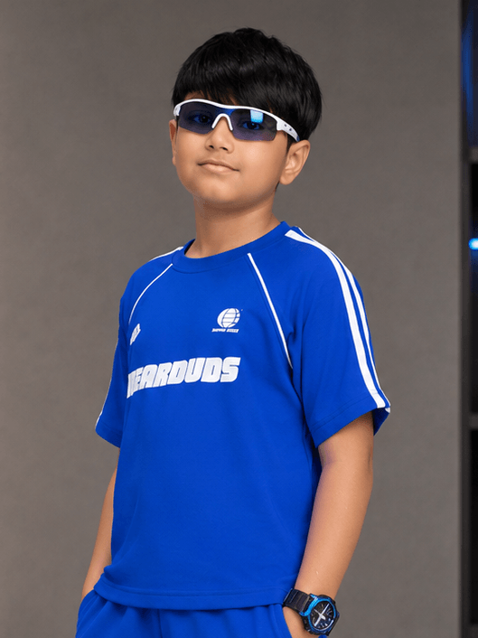KIDS ROSTER T-SHIRT BOYS GIRLS BLUE worn by a boy with sunglasses, showcasing a stylish casual look.
