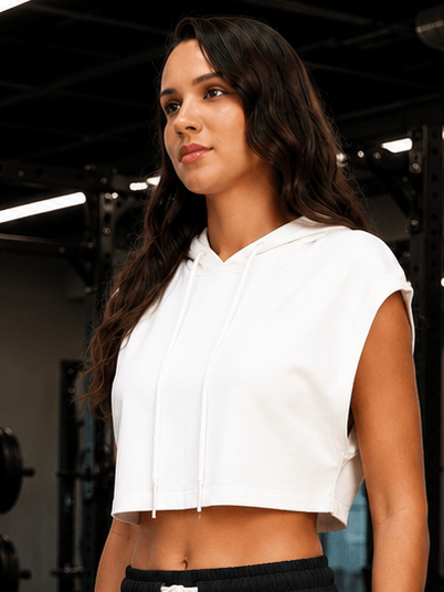 Women Studio Cut-Off Crop Hoodie T-Shirts White featuring a stylish woman in a gym setting.