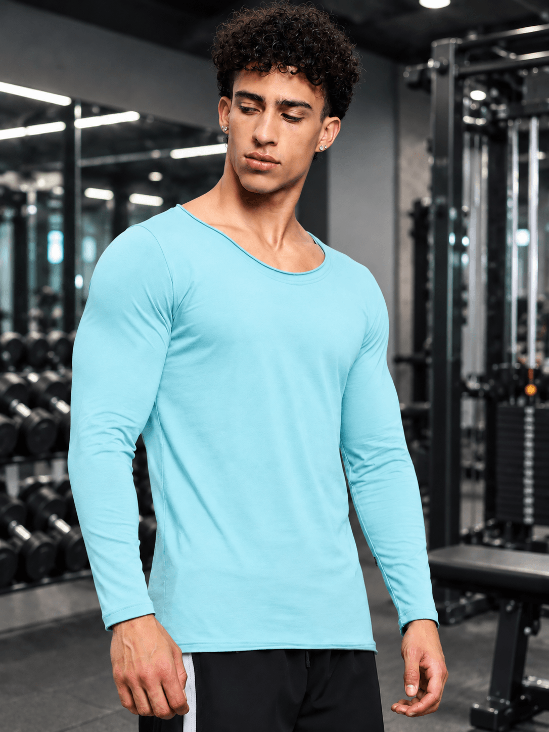 JOEL SLIM FIT COTTON SWEATSHIRT SKY BLUE worn by a model in a gym setting, showcasing its sleek design and color.