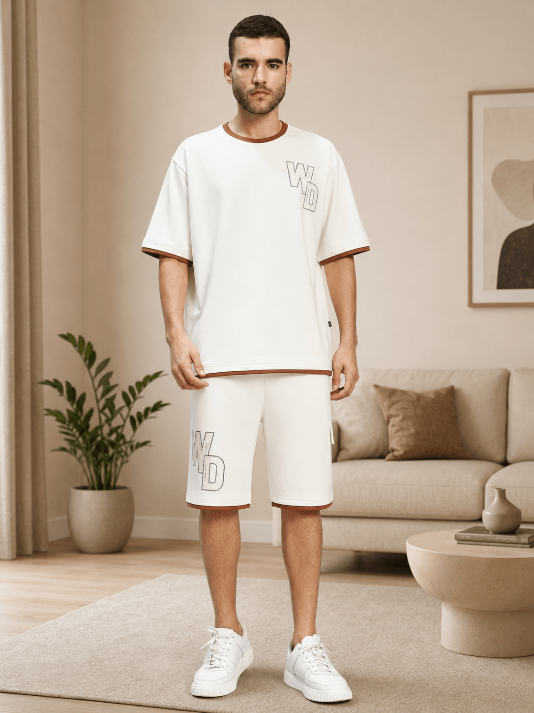 DOWNTOWN RELAXED FIT CO-ORD SET WHITE model showcasing contemporary style and comfort in a cozy living room setting.