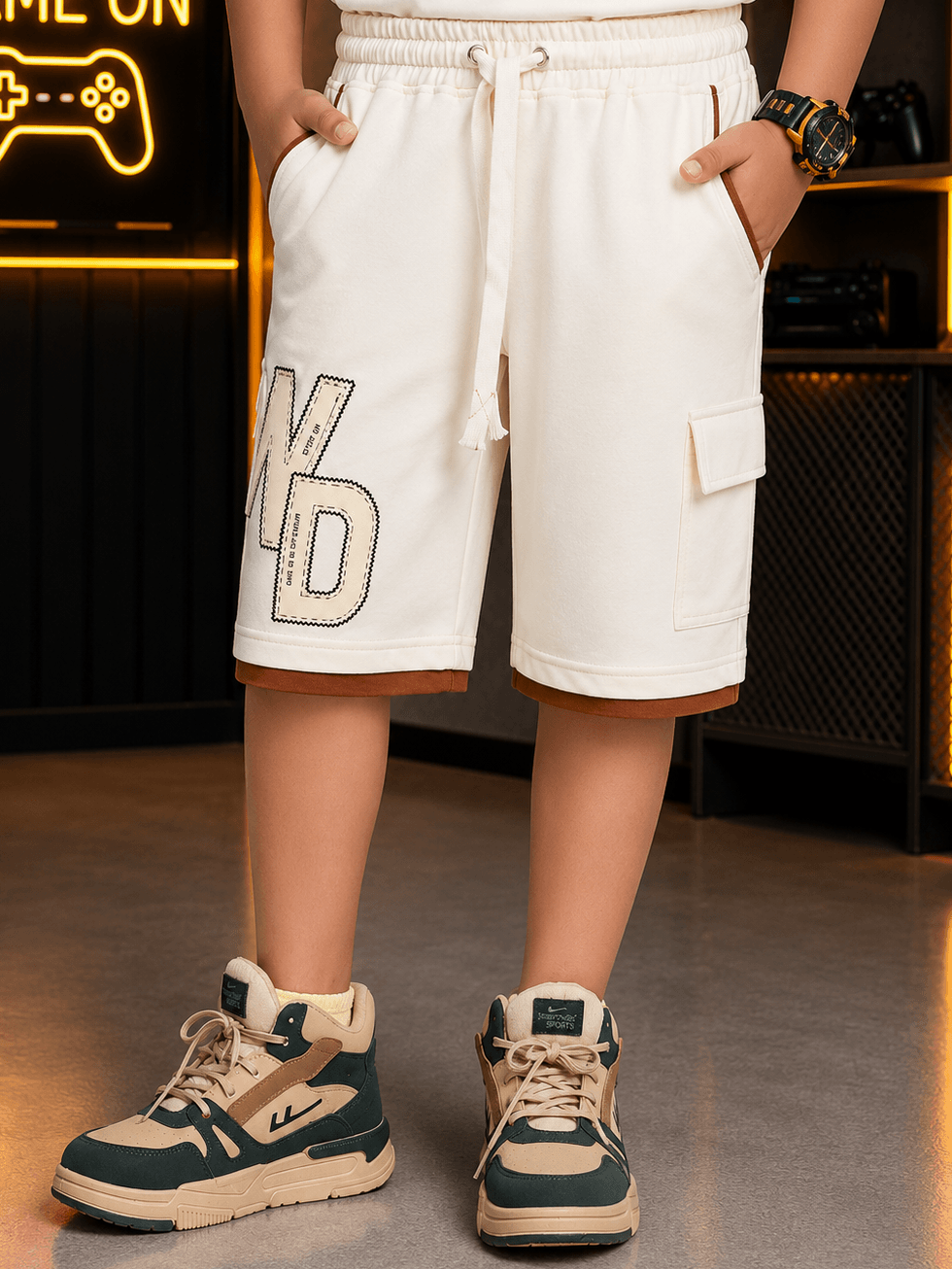 DOWNTOWN SHORTS FOR BOYS GIRLS OFF-WHITE worn by a boy, styled with sneakers and a casual look.