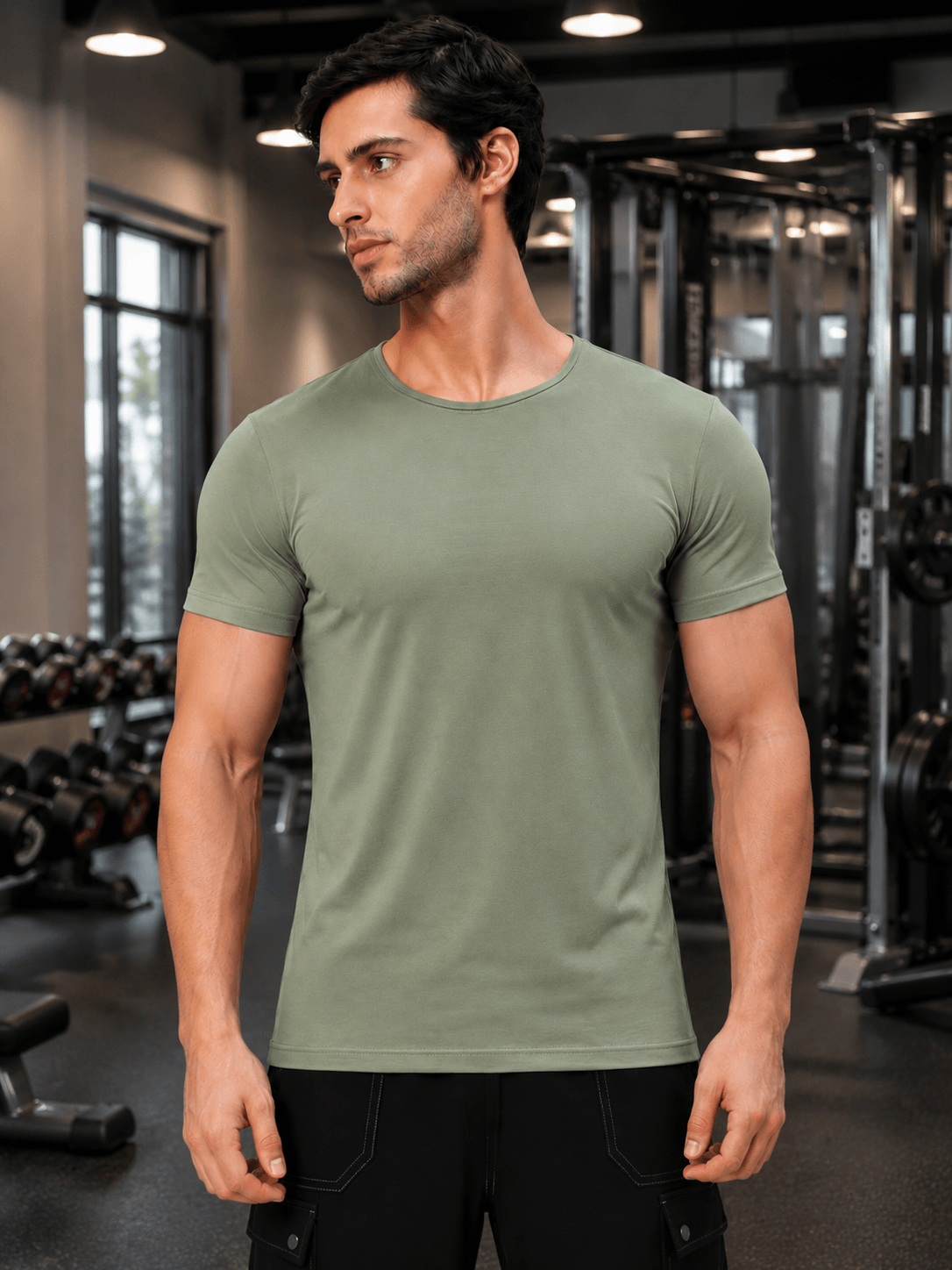 BEDROCK FIT REGULAR FIT T-SHIRT ROYAL SAGE GREEN model wearing the shirt in a gym setting.