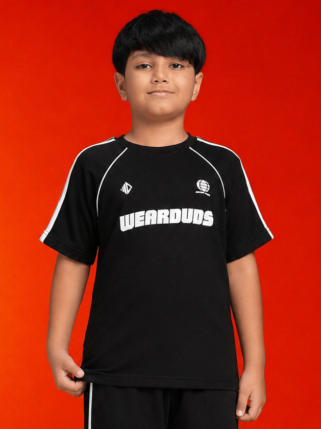 KIDS ROSTER T-SHIRT BOYS GIRLS BLACK WHITE modeled by a boy in a cool black shirt against a vibrant orange background.
