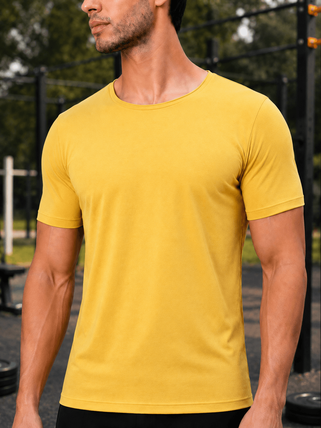 BEDROCK FIT REGULAR FIT T-SHIRT YELLOW worn by a fit man outdoors, showcasing its vibrant yellow color and comfortable style.