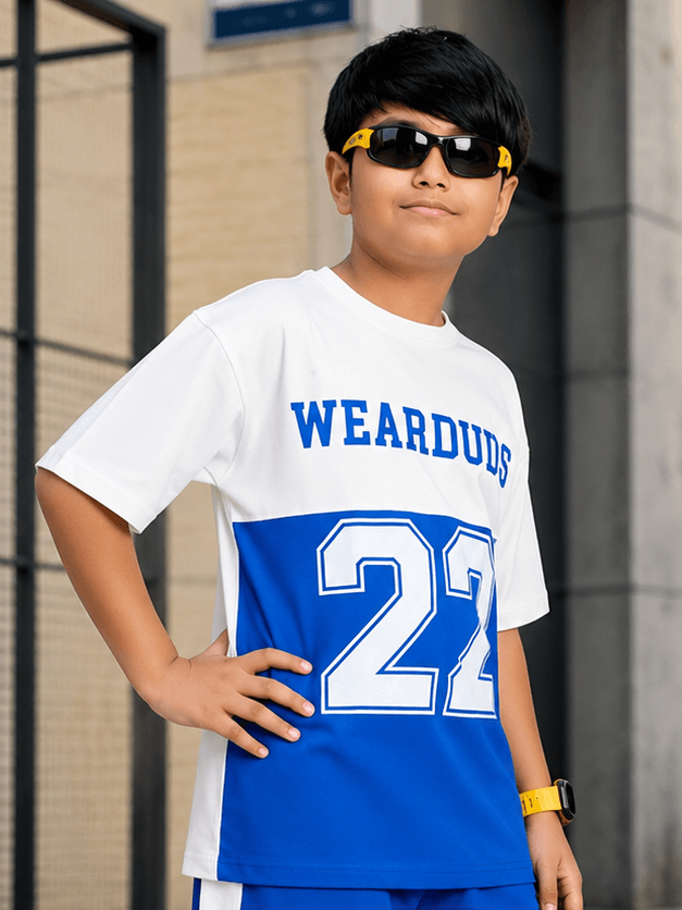 ELECTRIC FLEX T-SHIRT FOR BOYS GIRLS WHITE BLUE worn by a boy in sunglasses, posing outdoors in sporty style.