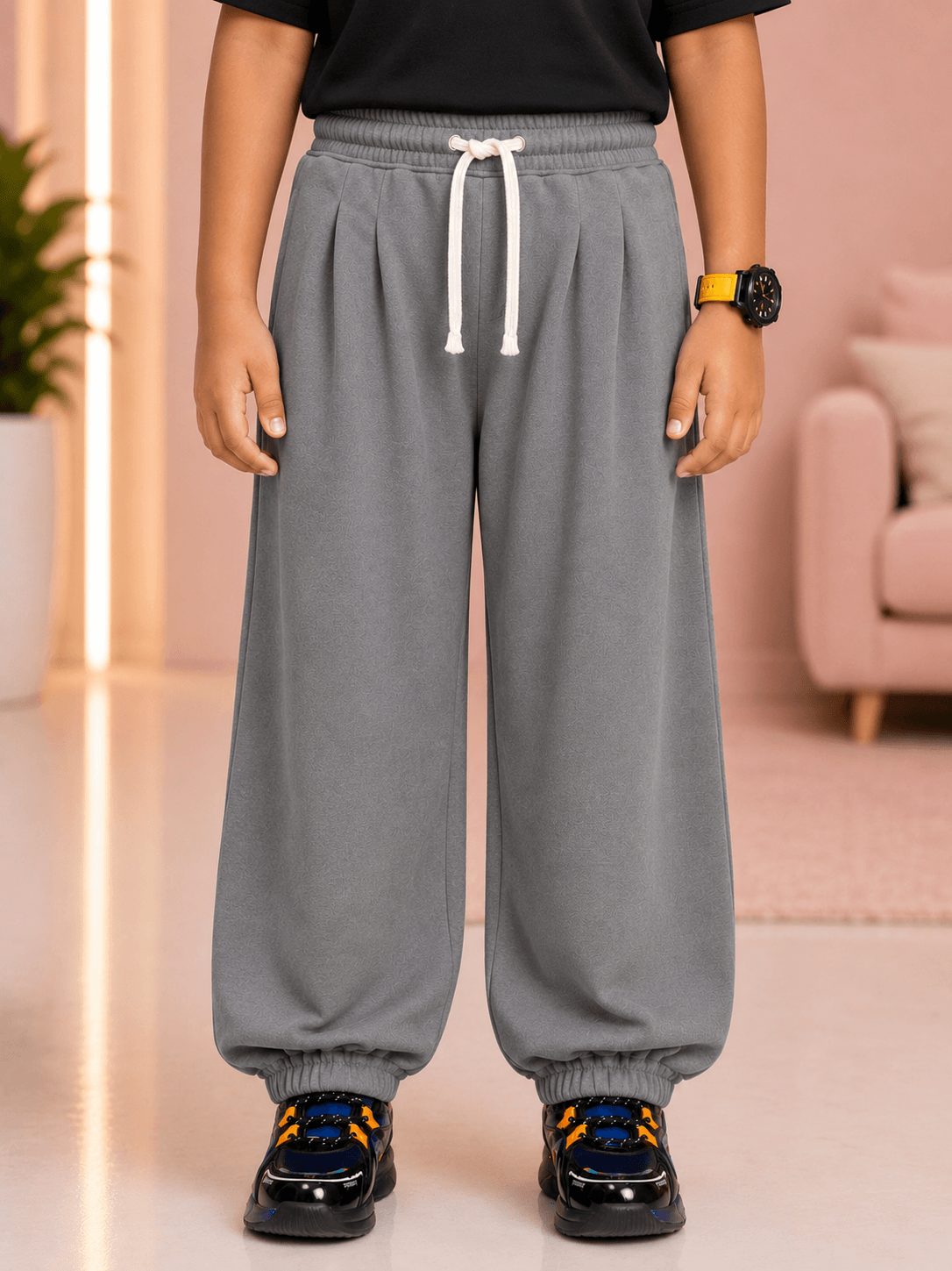 COOLFIT JOGGER FOR BOYS GIRLS GREY worn by child, featuring relaxed fit and elastic cuffs, perfect for casual wear.
